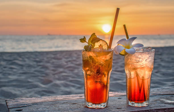 drinks with blur beach and sunset in background