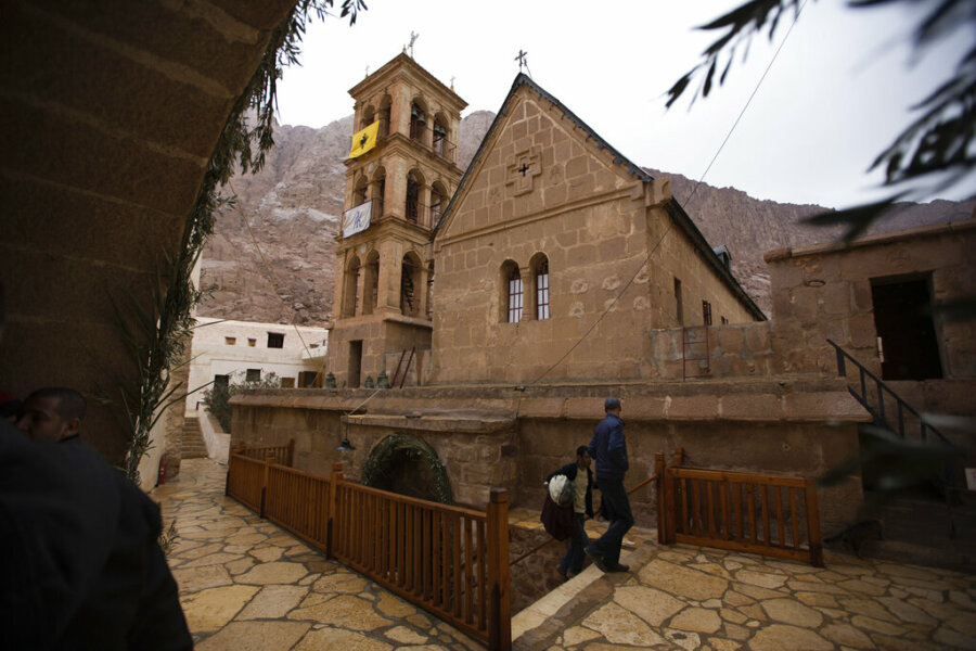 In this photo taken Sunday, Dec. 9, 2013, people visit Saint Catherine's Monastery, also known as Santa Katarina, at the foot of Mount Sinai in Saint Catherine in the Sinai peninsula, Egypt. The monastery is Greek Orthodox and is a UNESCO World Heritage Site. (AP Photo/Hiro Komae)